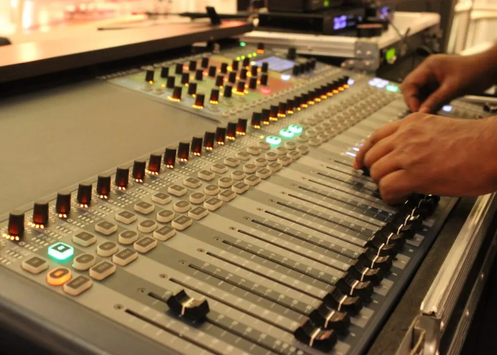 Sound engineer operating a mixing console