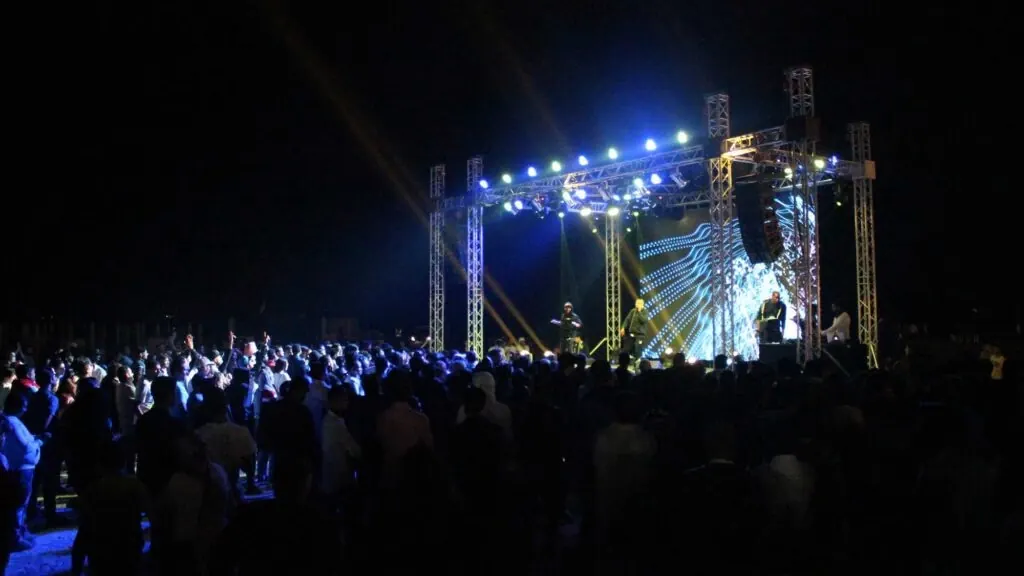 Outdoor night concert with truss stage lighting